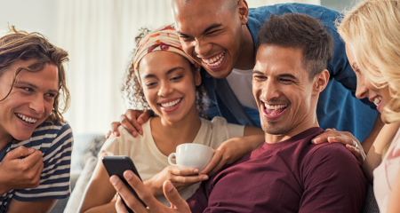 groups of friends laughing over video on social media